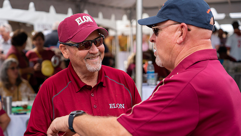 Photo of two male alumnis at homecoming